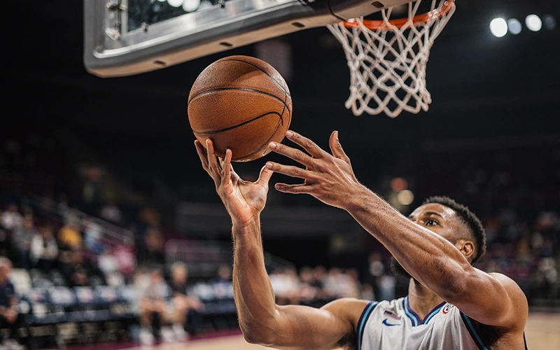 NBA player making a three-point shot during a game